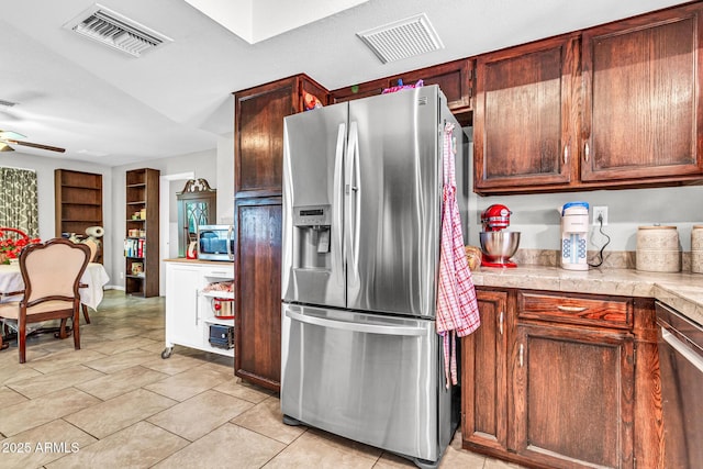 6055 E Hannibal St, Mesa, AZ 85205 - kitchen with stainless steel appliances, ceiling fan, light tile patterned floors, and tile countertops