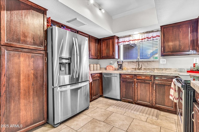 6055 E Hannibal St, Mesa, AZ 85205 - kitchen featuring appliances with stainless steel finishes, light countertops, light tile patterned floors, and a raised ceiling
