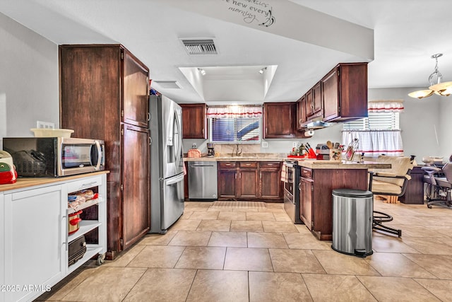 6055 E Hannibal St, Mesa, AZ 85205 - kitchen with appliances with stainless steel finishes, under cabinet range hood, light countertops, a raised ceiling, and a peninsula