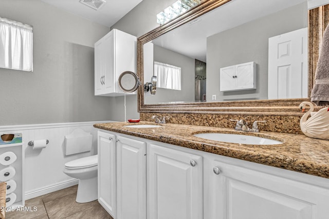 6055 E Hannibal St, Mesa, AZ 85205 - bathroom featuring double vanity, tile patterned floors, wainscoting, and a shower
