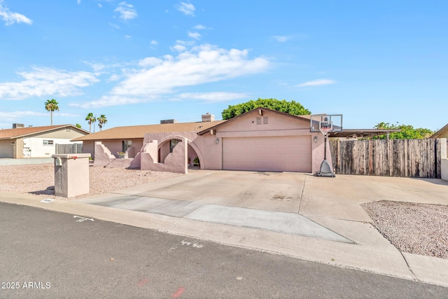 6055 E Hannibal St, Mesa, AZ 85205 - view of front of property featuring an attached garage, stucco siding, concrete driveway, and a chimney
