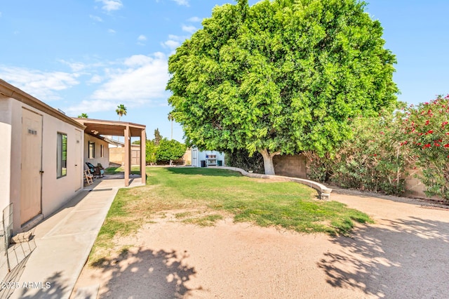 6055 E Hannibal St, Mesa, AZ 85205 - view of green lawn with a storage unit and a patio