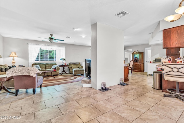 6055 E Hannibal St, Mesa, AZ 85205 - living room featuring a ceiling fan and light tile patterned flooring