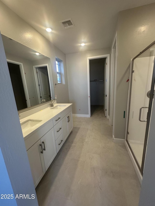 bathroom featuring vanity and a shower with shower door