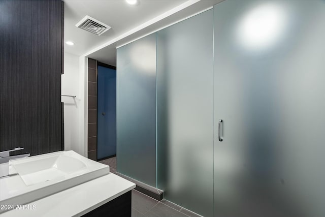 bathroom featuring tile patterned flooring and vanity