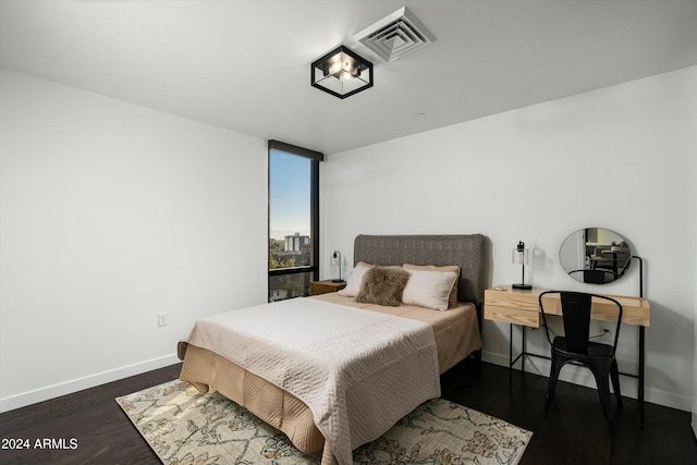 bedroom featuring dark hardwood / wood-style flooring and expansive windows