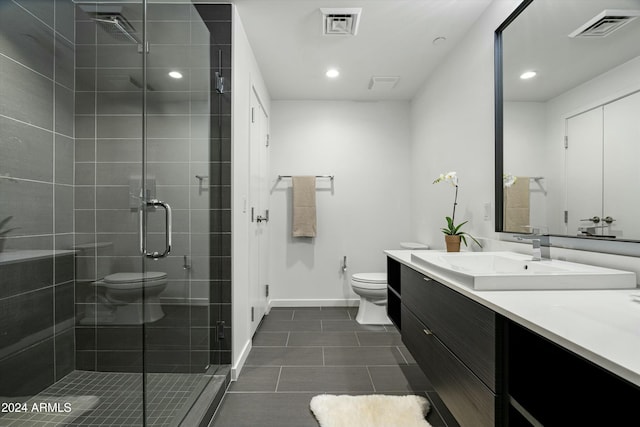 bathroom featuring tile patterned floors, vanity, toilet, and walk in shower