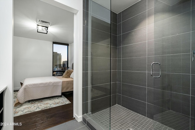 bathroom featuring wood-type flooring and walk in shower