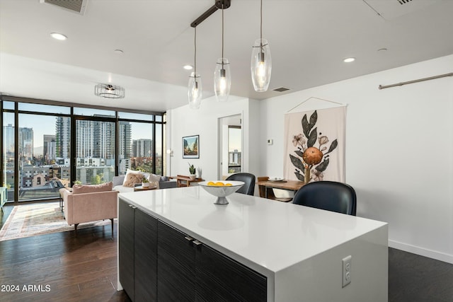 kitchen featuring pendant lighting, a center island, floor to ceiling windows, and dark wood-type flooring