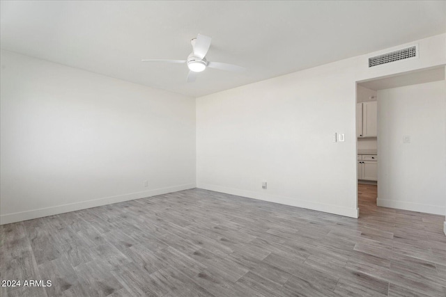 spare room with ceiling fan and light hardwood / wood-style flooring