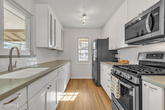 kitchen with white cabinetry, plenty of natural light, and appliances with stainless steel finishes