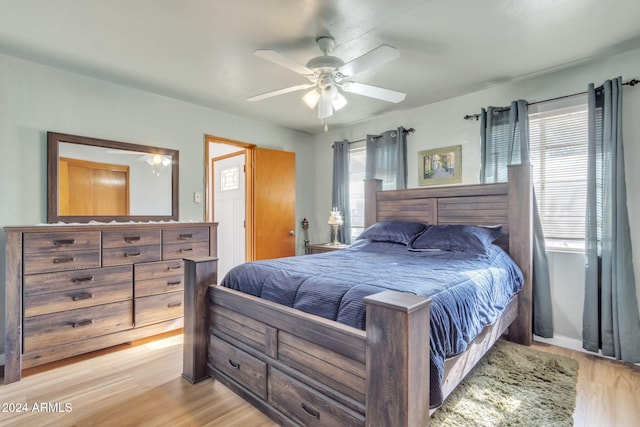 bedroom with ceiling fan and light wood-type flooring