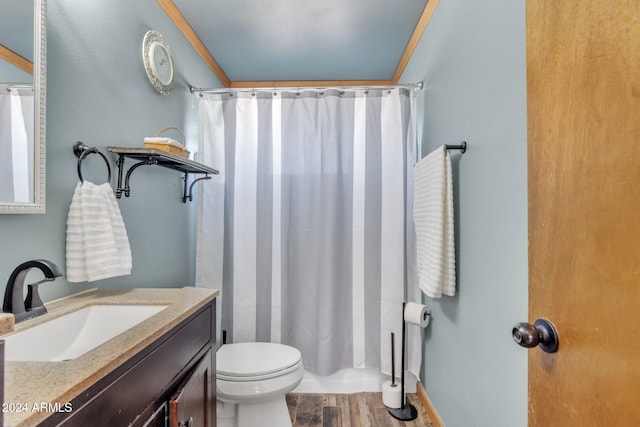 bathroom with hardwood / wood-style flooring, vanity, curtained shower, and toilet