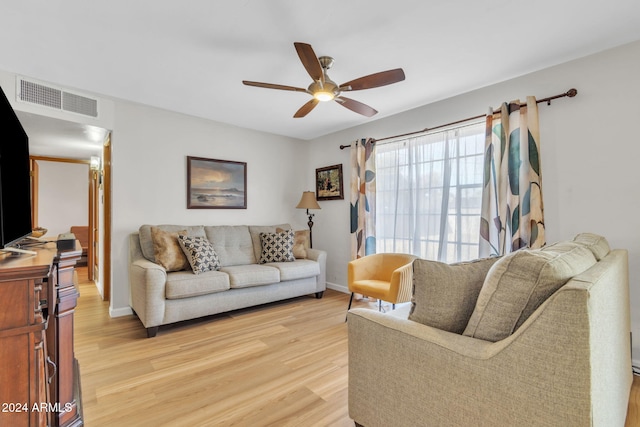 living room featuring ceiling fan and light hardwood / wood-style floors