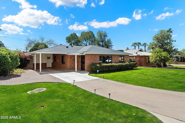 1939 E Solano Dr, Phoenix, AZ 85016 - view of front facade with brick siding, a front yard, driveway, and a carport