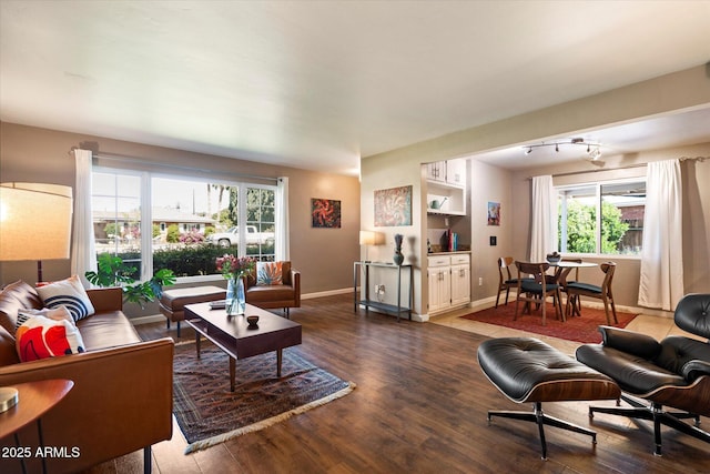 1939 E Solano Dr, Phoenix, AZ 85016 - living room featuring baseboards and dark wood-style floors