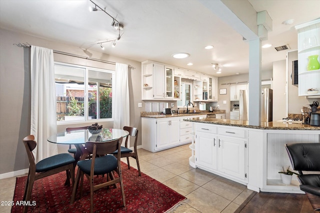 1939 E Solano Dr, Phoenix, AZ 85016 - kitchen featuring a sink, refrigerator, white cabinetry, dark stone countertops, and visible vents