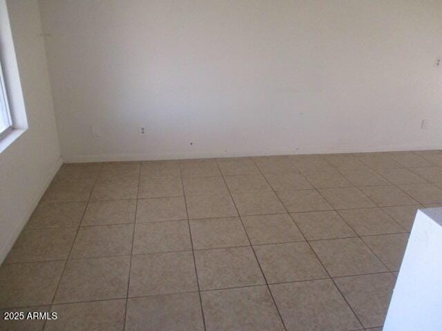 spare room with light tile patterned floors