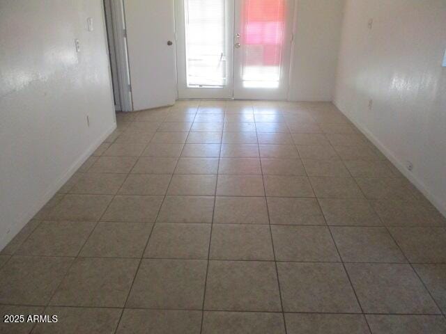 unfurnished room with light tile patterned floors