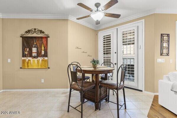 dining room with crown molding, ceiling fan, and french doors