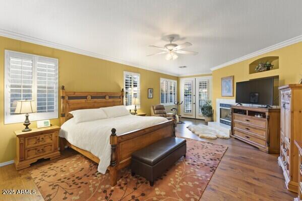 bedroom featuring dark wood-type flooring, access to outside, ornamental molding, and ceiling fan