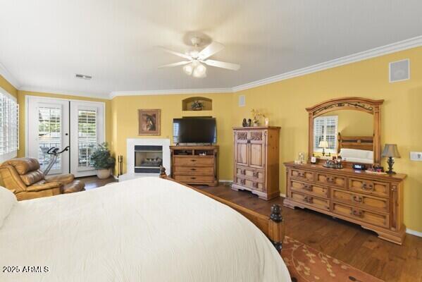 bedroom featuring dark wood-type flooring, ceiling fan, access to exterior, ornamental molding, and french doors