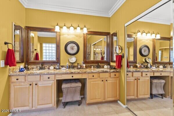 bathroom featuring crown molding and vanity