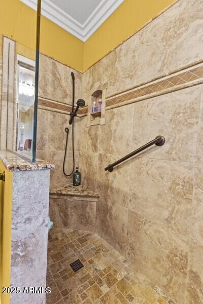 bathroom featuring crown molding and tiled shower