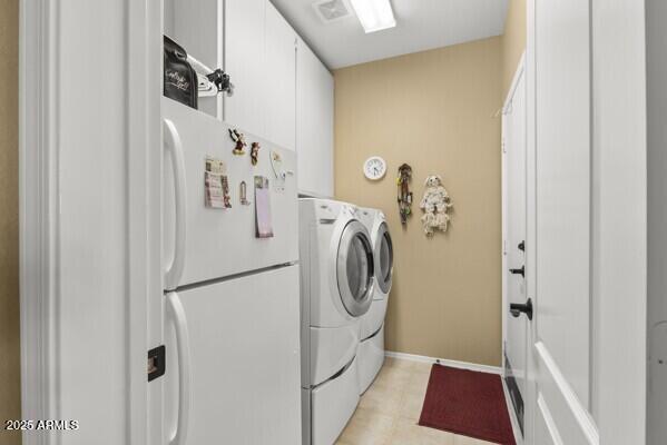 washroom with cabinets and washer and dryer