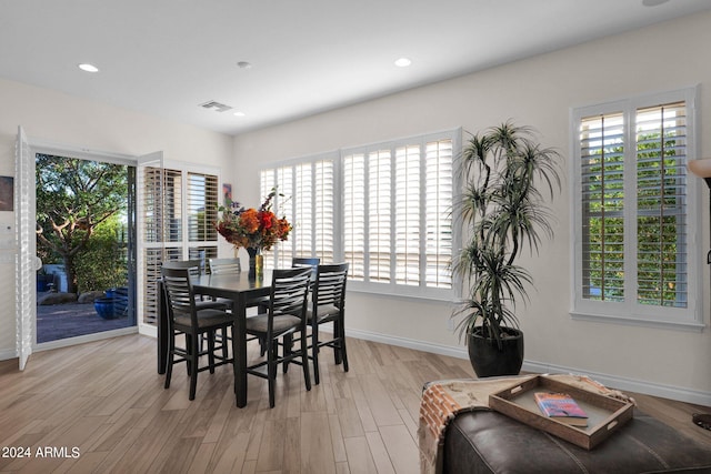 dining area featuring a healthy amount of sunlight and light hardwood / wood-style flooring