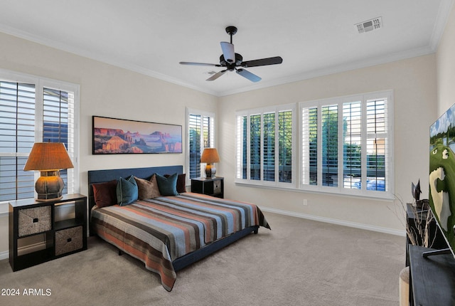 carpeted bedroom featuring ceiling fan, ornamental molding, and multiple windows