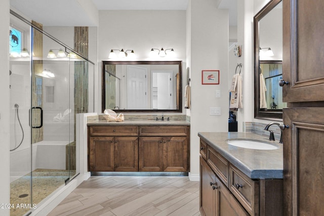 bathroom with vanity, wood-type flooring, and walk in shower