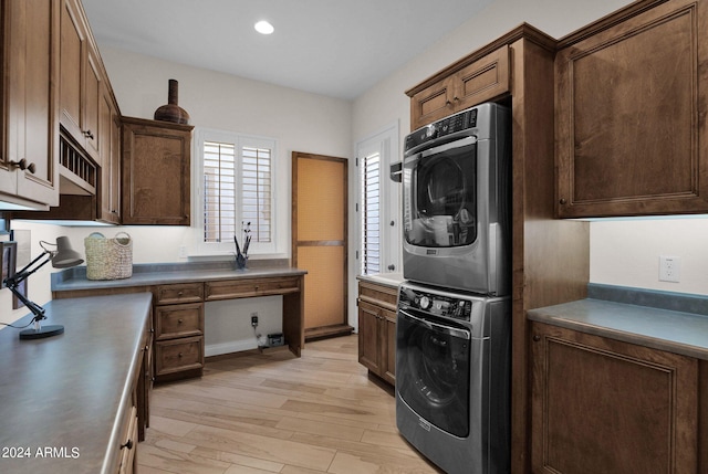 kitchen featuring light wood-type flooring and stacked washer and clothes dryer