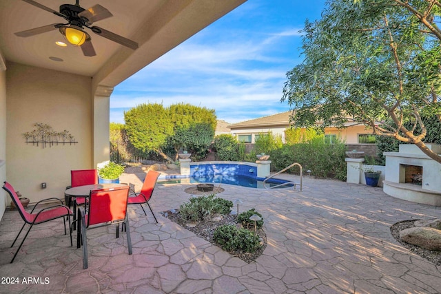 view of patio featuring ceiling fan and an outdoor fireplace