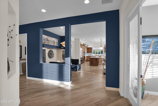 corridor featuring light hardwood / wood-style floors