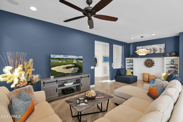 living room with light wood-type flooring and ceiling fan