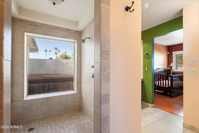 bathroom featuring hardwood / wood-style flooring and tiled shower