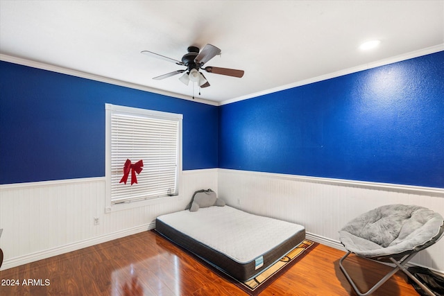 bedroom with ceiling fan, wood-type flooring, and ornamental molding