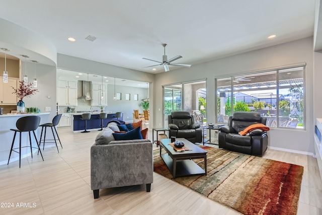 living room with ceiling fan and sink