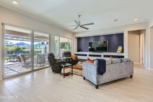 living room with ceiling fan, light tile patterned floors, and a wealth of natural light