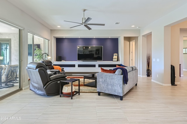 tiled living room featuring ceiling fan