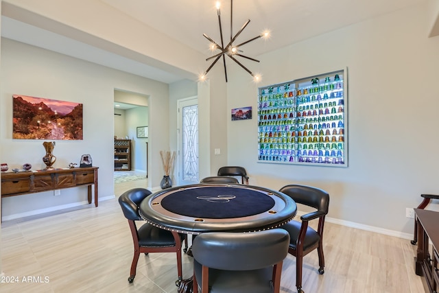 game room featuring light hardwood / wood-style floors and an inviting chandelier