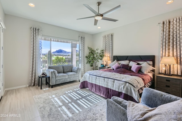 bedroom with a mountain view and ceiling fan