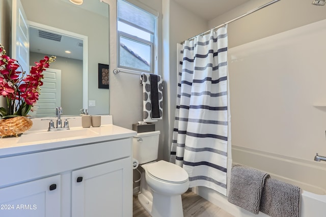 full bathroom featuring vanity, hardwood / wood-style floors, shower / bath combination with curtain, and toilet