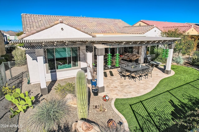 rear view of house with a gazebo, a yard, and a patio