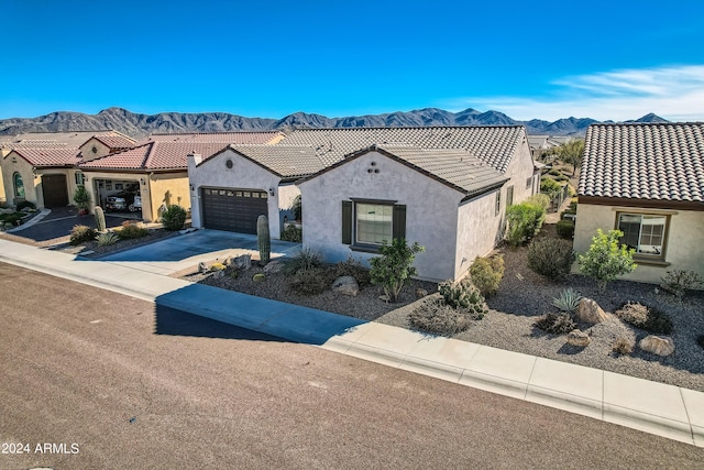 mediterranean / spanish-style house with a mountain view and a garage