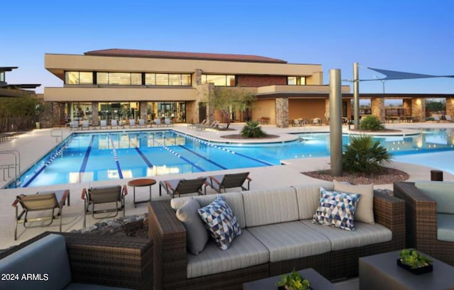 view of pool with an outdoor living space and a patio