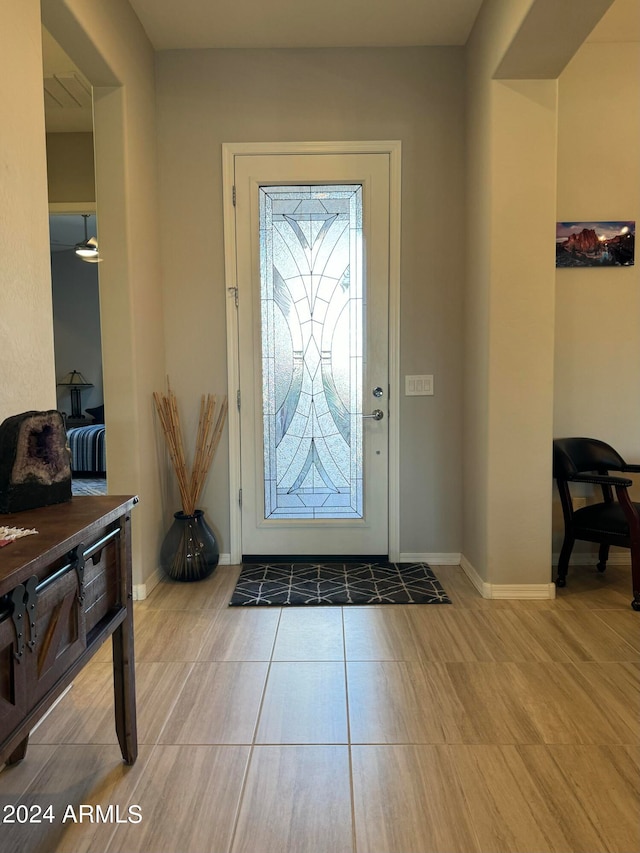 entryway with light tile patterned flooring