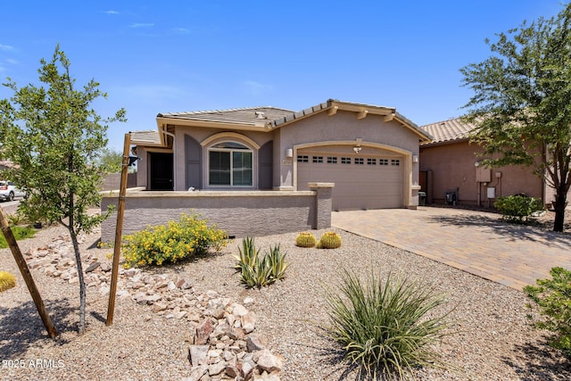 4230 W Palace Station Rd, New River, AZ 85087 - view of front facade with a garage, stucco siding, decorative driveway, and a tiled roof