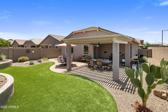 4230 W Palace Station Rd, New River, AZ 85087 - back of property with ceiling fan, a fenced backyard, a patio area, and stucco siding
